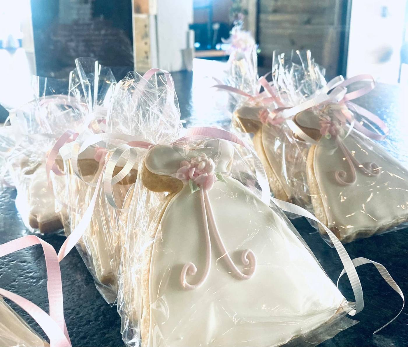 Wedding dress sugar cookie favors tied with pink ribbon