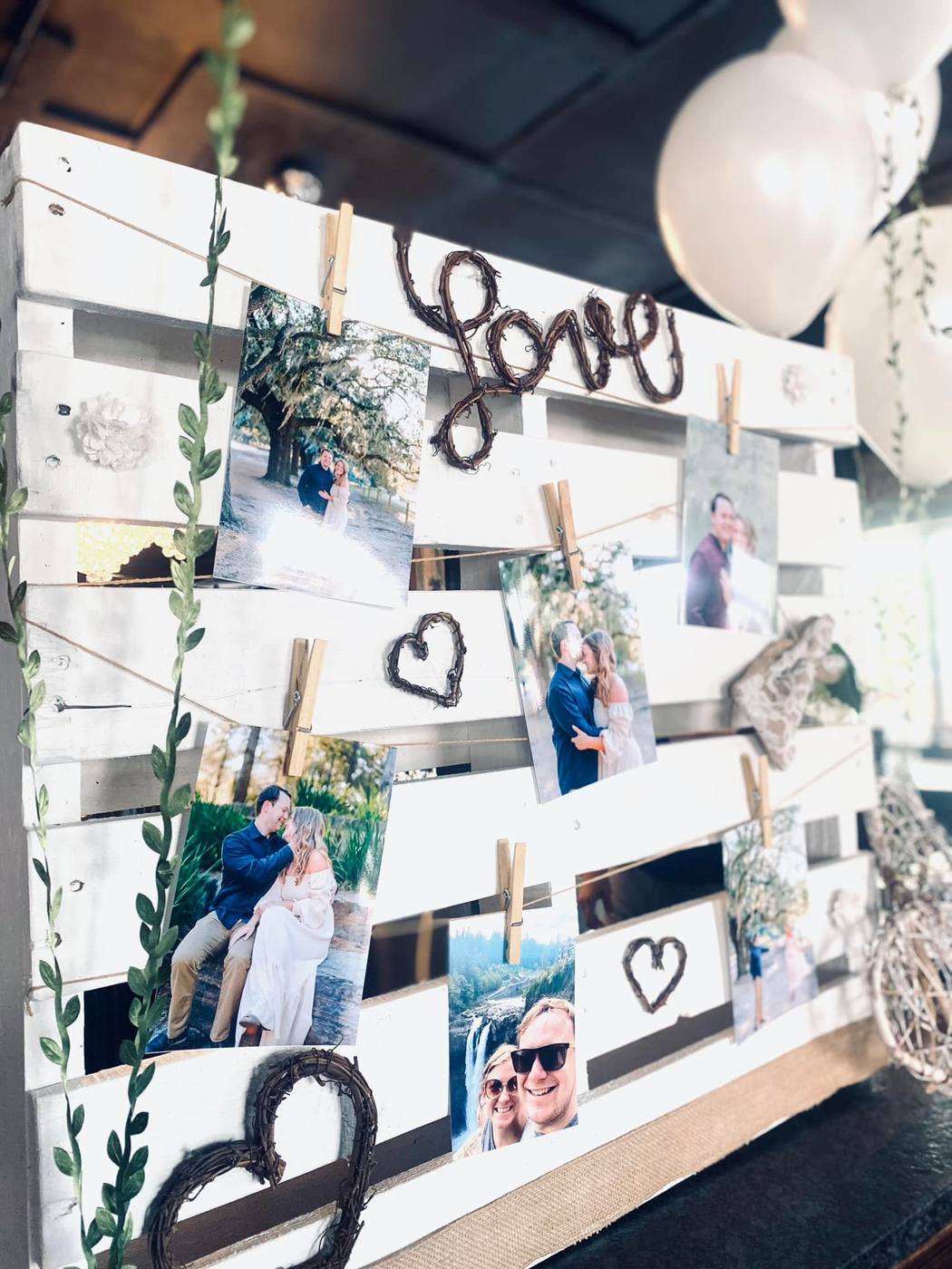 Engagement photo display with grapevine love lettering and white balloons