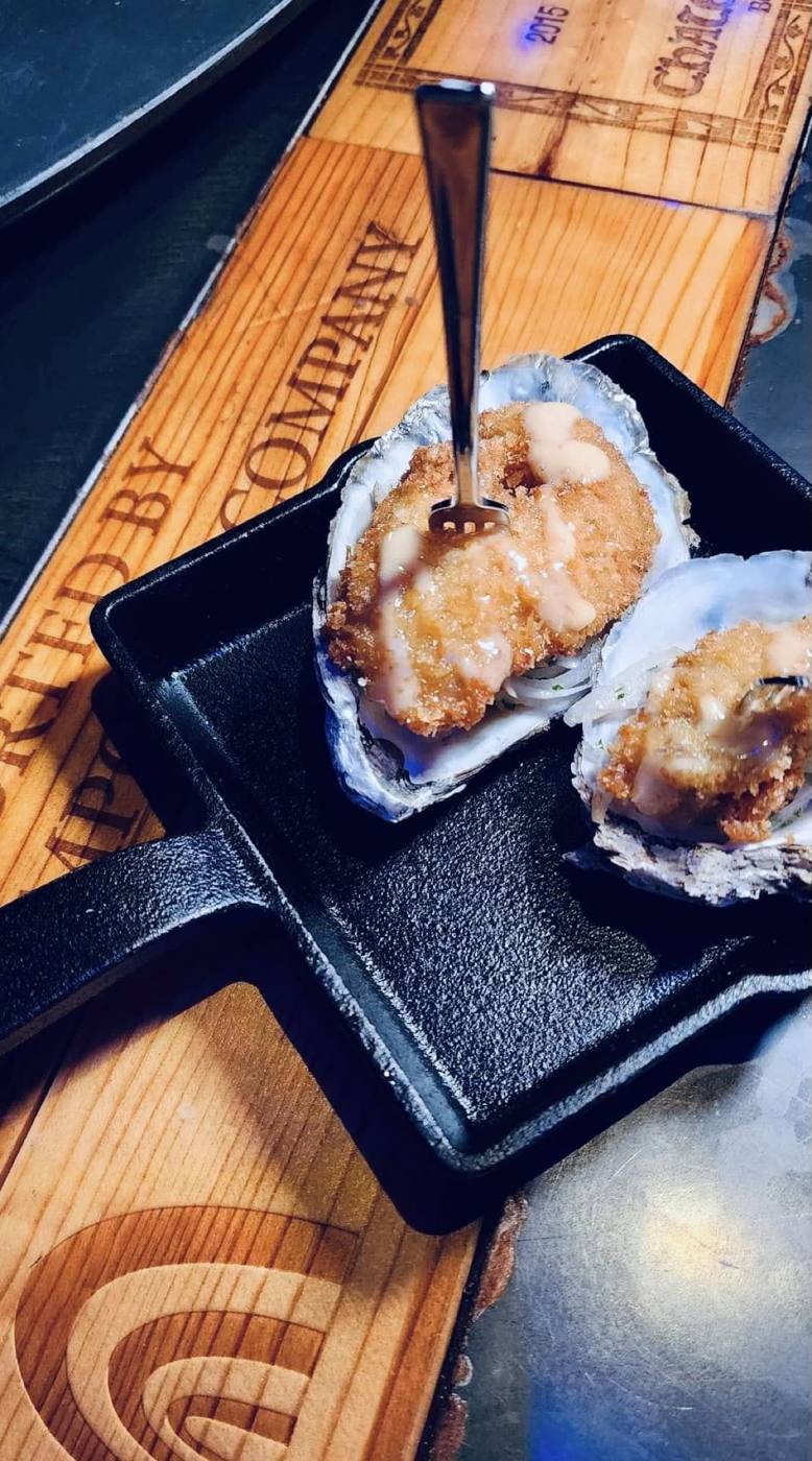 Crispy fried oysters on the half shell